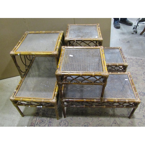 2232 - Three woven wickerwork two-tier occasional tables, each measuring 62 cm high, 66 x 41cm (3)