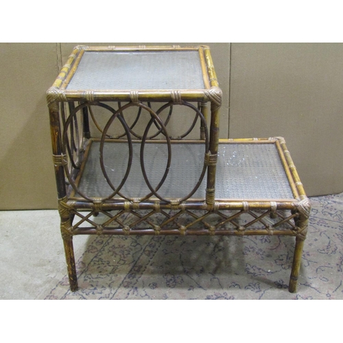 2232 - Three woven wickerwork two-tier occasional tables, each measuring 62 cm high, 66 x 41cm (3)