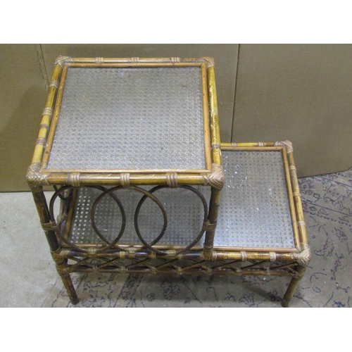 2232 - Three woven wickerwork two-tier occasional tables, each measuring 62 cm high, 66 x 41cm (3)