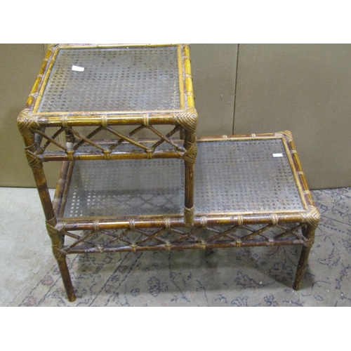 2232 - Three woven wickerwork two-tier occasional tables, each measuring 62 cm high, 66 x 41cm (3)