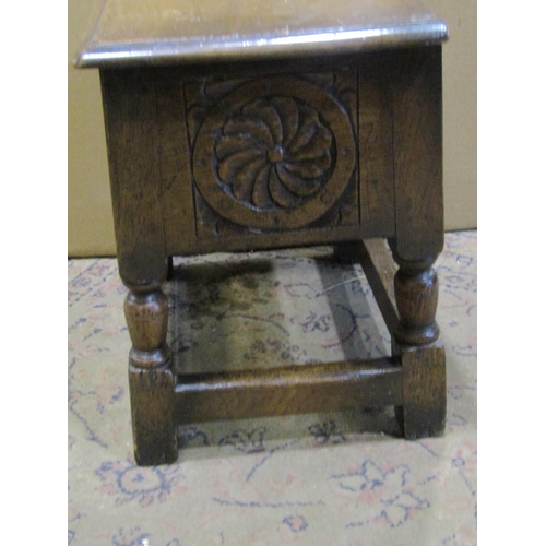 2233 - A carved oak work box in the old English style  and an oak wall mirror (2)