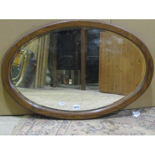 2233 - A carved oak work box in the old English style  and an oak wall mirror (2)