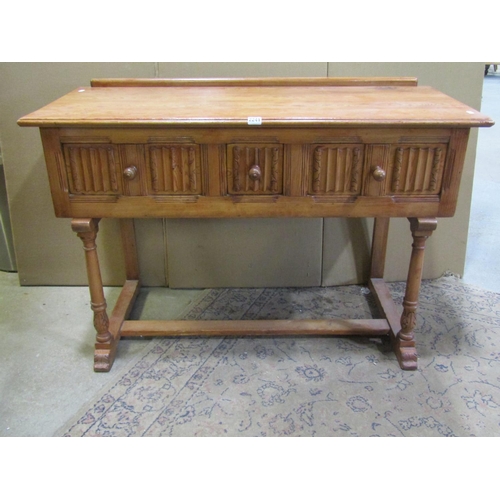 2241 - A small pine side / dressing table, in the Old English / refectory style, fitted with linen fold car... 