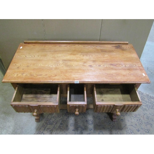 2241 - A small pine side / dressing table, in the Old English / refectory style, fitted with linen fold car... 