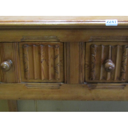 2241 - A small pine side / dressing table, in the Old English / refectory style, fitted with linen fold car... 