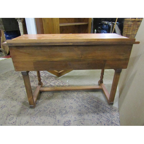 2241 - A small pine side / dressing table, in the Old English / refectory style, fitted with linen fold car... 