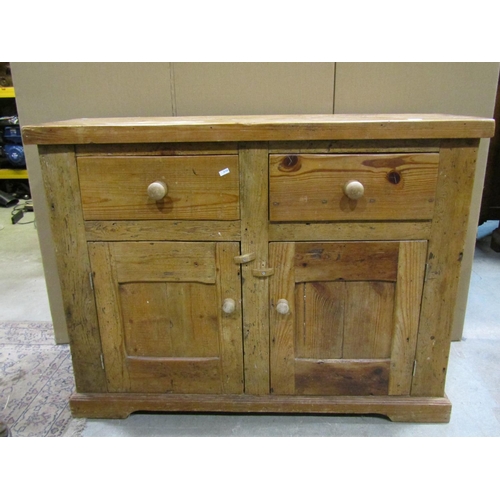 2257 - An old stripped pine dresser base, fitted with a pair of drawers and panelled doors, 92cm high, 120 ... 