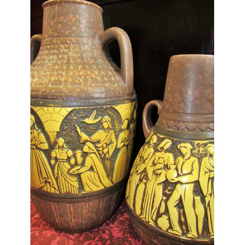 1076 - Two large mid 20th century twin handled West German ceramic vessels, decorated with stylised figural... 