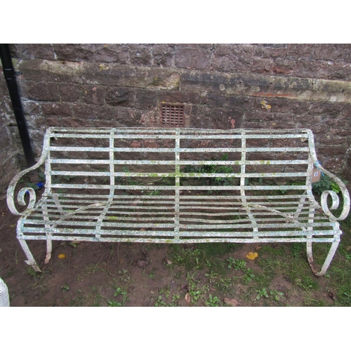 2064 - A good painted and weathered 19th century iron strapwork garden bench with simple open scrolled arms... 