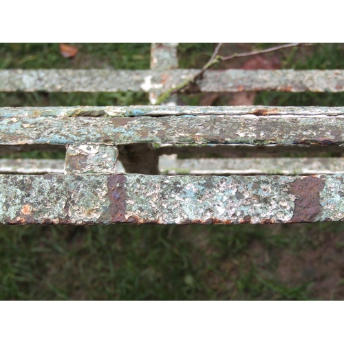 2064 - A good painted and weathered 19th century iron strapwork garden bench with simple open scrolled arms... 