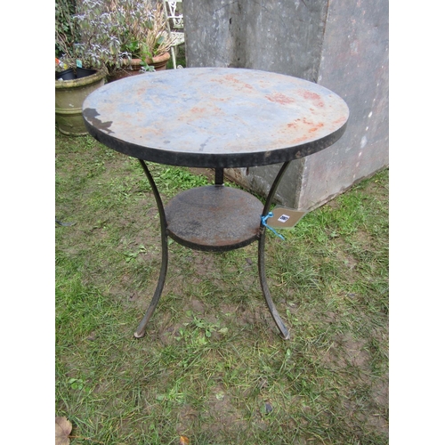 2067 - A heavy gauge but small steel circular two tier garden terrace table raised on three swept supports,... 