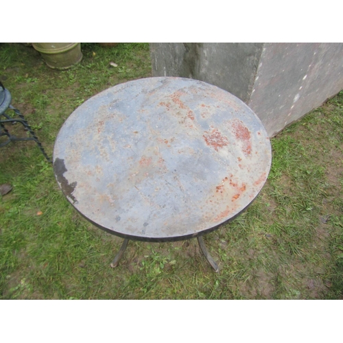 2067 - A heavy gauge but small steel circular two tier garden terrace table raised on three swept supports,... 