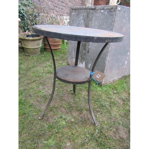 2067 - A heavy gauge but small steel circular two tier garden terrace table raised on three swept supports,... 