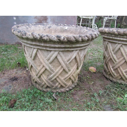 2068 - A pair of  weathered good quality cast composition stone garden planters in the form of circular bas... 