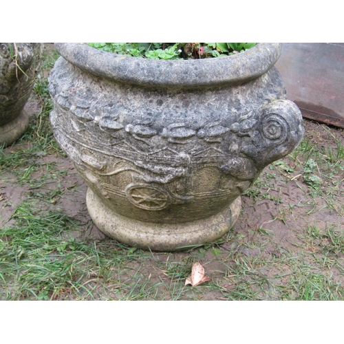 2068A - A pair of weathered cast composition stone circular garden planters in the form of Roman urns with r... 