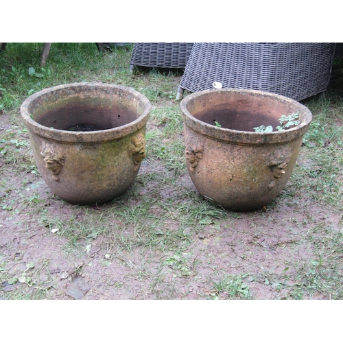 2073 - A pair of weathered buff coloured terracotta circular tapered planters with moulded rims and repeati... 