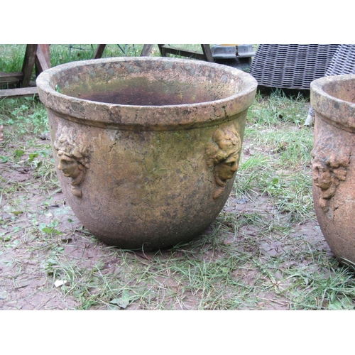 2073 - A pair of weathered buff coloured terracotta circular tapered planters with moulded rims and repeati... 