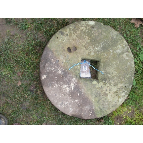 2078 - A weathered millstone with central square cut out, 61 cm diameter x 10 cm thick