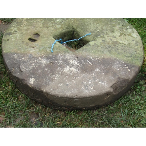 2078 - A weathered millstone with central square cut out, 61 cm diameter x 10 cm thick