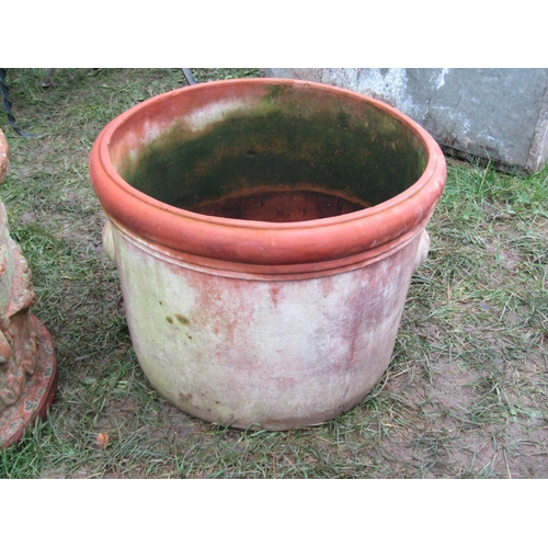 2081 - A weathered squat cylindrical terracotta planter with repeating raised relief winged cherub and frui... 