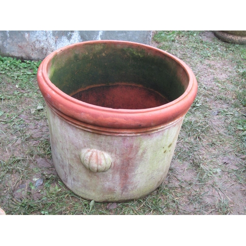 2081 - A weathered squat cylindrical terracotta planter with repeating raised relief winged cherub and frui... 