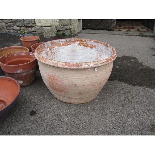 2096 - A weathered terracotta planter of squat circular form (af) 51cm diameter x 31cm high together with s... 