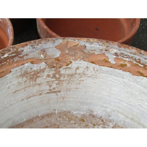 2096 - A weathered terracotta planter of squat circular form (af) 51cm diameter x 31cm high together with s... 