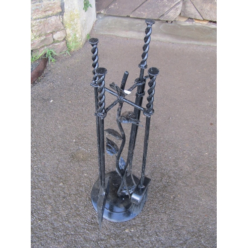 2138A - An unusual iron work fireside companion set with leafed stem support