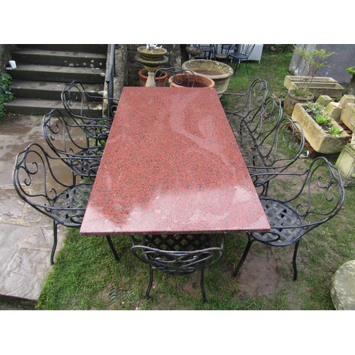 2080 - A heavy gauge ironwork garden suite comprising table with additional polished rectangular marble pos... 