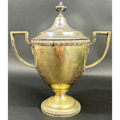 A Tiffany & Co silver plated twin-handled lidded trophy cup, with applied badge to underside ‘Tiffany & co, Broadway, New York’, together with Tiffany & Co Sterling silver lighter (2)