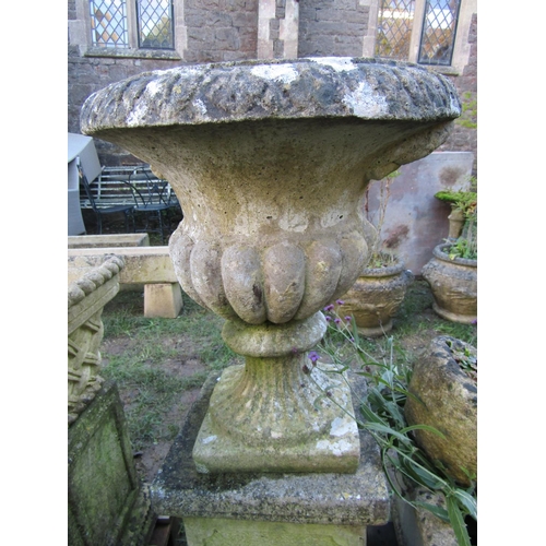 2074 - A weathered cast composition stone garden urn the circular lobed bowl with egg and dart flared rim r... 