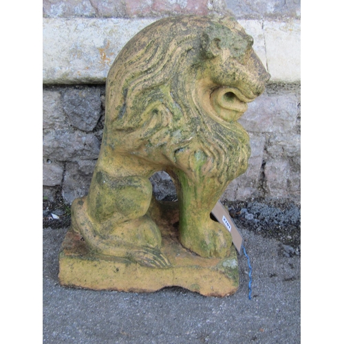 2101 - A weathered buff coloured garden terrace/pier ornament in the form of a seated lion (af), 52 cm high... 