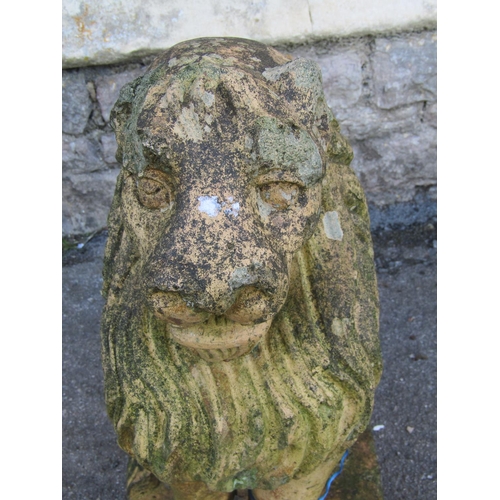 2101 - A weathered buff coloured garden terrace/pier ornament in the form of a seated lion (af), 52 cm high... 