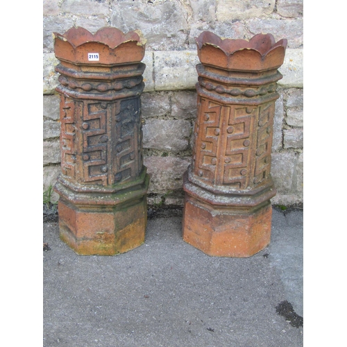 2115 - A pair of 19th century, moulded, terracotta chimney pots with geometric panelled motifs, 74cm high.