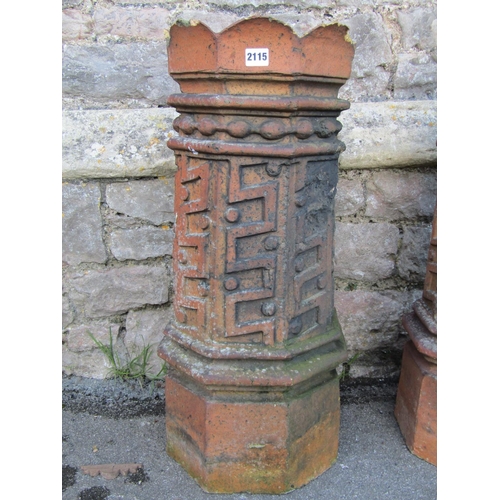 2115 - A pair of 19th century, moulded, terracotta chimney pots with geometric panelled motifs, 74cm high.