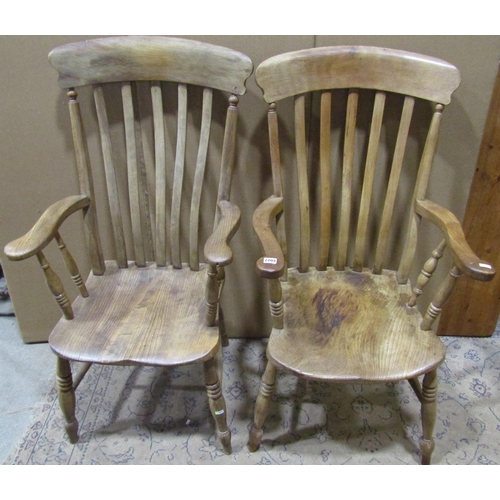 2202 - Two similar antique Windsor elm and beechwood lathe back elbow chairs with saddle shaped seats