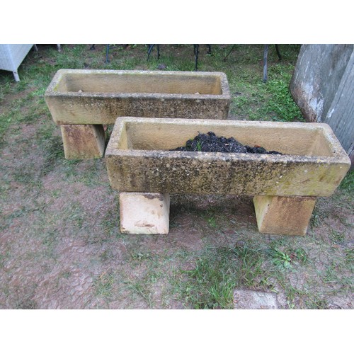 2075 - A pair of weathered composition stone planters of rectangular form, 19cm high, 86 x 26, raised on mi... 