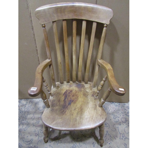 2202 - Two similar antique Windsor elm and beechwood lathe back elbow chairs with saddle shaped seats