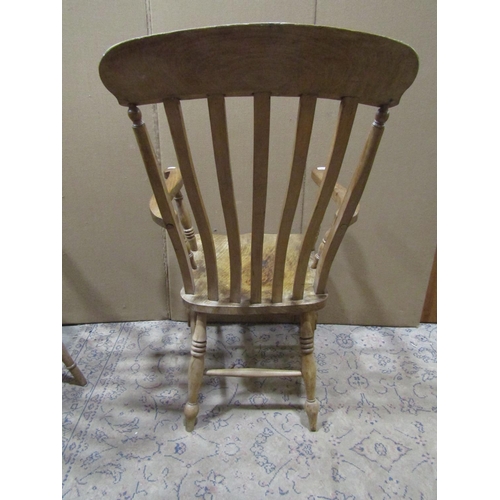 2202 - Two similar antique Windsor elm and beechwood lathe back elbow chairs with saddle shaped seats