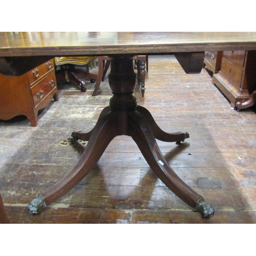 2733 - Georgian mahogany snap top breakfast table. 120cm x 95cm. On turned pillar and quadruped