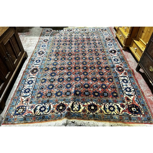 1815 - A large Veramin Minakhani carpet with an allover floral pattern on a dark blue ground, 300 x 210 cm ... 