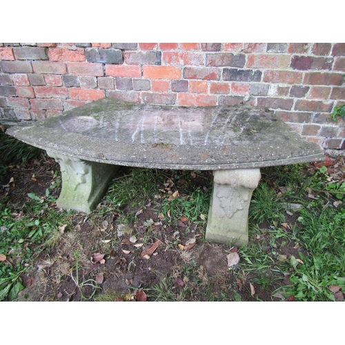 2041 - A weathered composition stone bench of curved form raised on scrolled acanthus supports, 43cm high, ... 