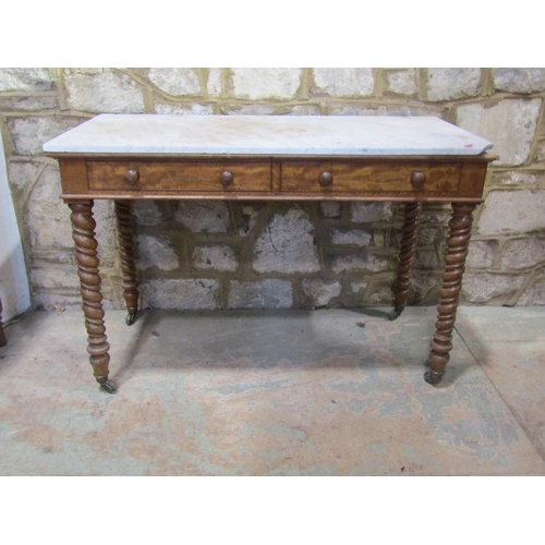 2207 - A late 19th century marble-topped satinwood table, fitted with twin frieze drawers, raised on twiste... 