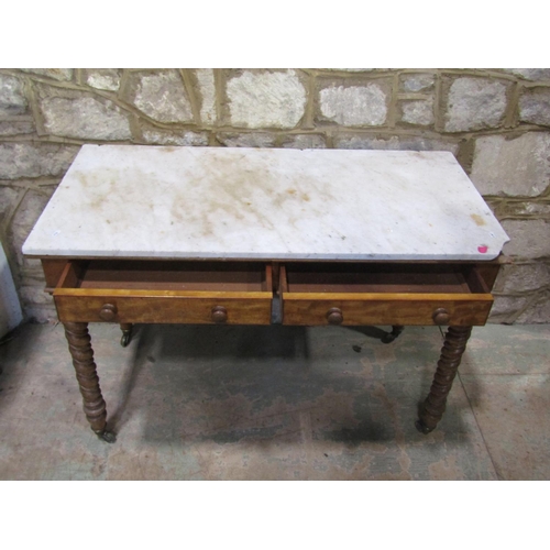 2207 - A late 19th century marble-topped satinwood table, fitted with twin frieze drawers, raised on twiste... 