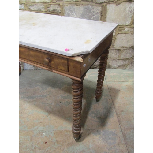 2207 - A late 19th century marble-topped satinwood table, fitted with twin frieze drawers, raised on twiste... 