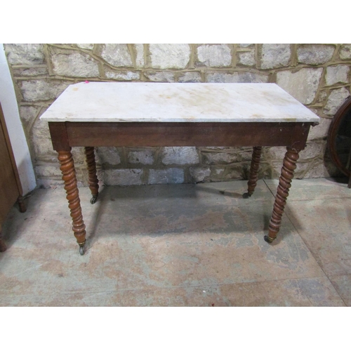 2207 - A late 19th century marble-topped satinwood table, fitted with twin frieze drawers, raised on twiste... 