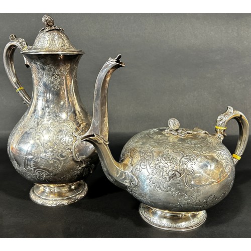 1175 - A four piece Victorian silver tea service, tea and coffee pots, milk jug and sugar bowl, heavily eng... 