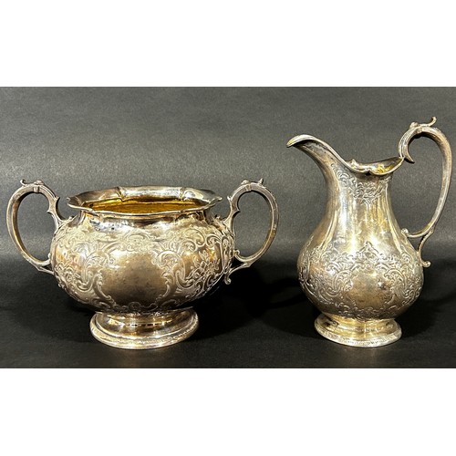 1175 - A four piece Victorian silver tea service, tea and coffee pots, milk jug and sugar bowl, heavily eng... 