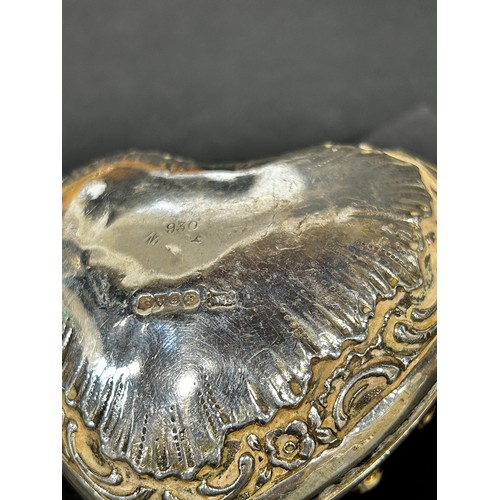 1190 - A silver heart shaped trinket box with a wine harvest scene to the centre surrounded by multi colour... 