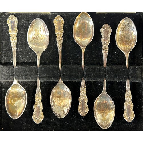 1174 - A cased set of six silver coffee spoons, a pair of squat candlesticks, a scent bottle with a silver ... 